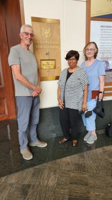 Dave Post, Laura Nottingham, and Marilyn Miller standing in front of Courtroom 4C in Greenbelt, MD.